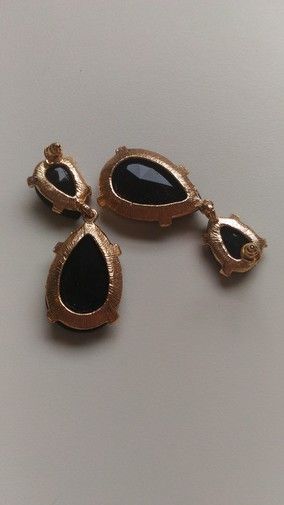 Pendientes negros y dorados.
