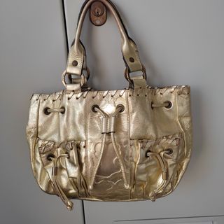 Bolso Tous Dorado piel de segunda mano por 30 EUR en Málaga en WALLAPOP