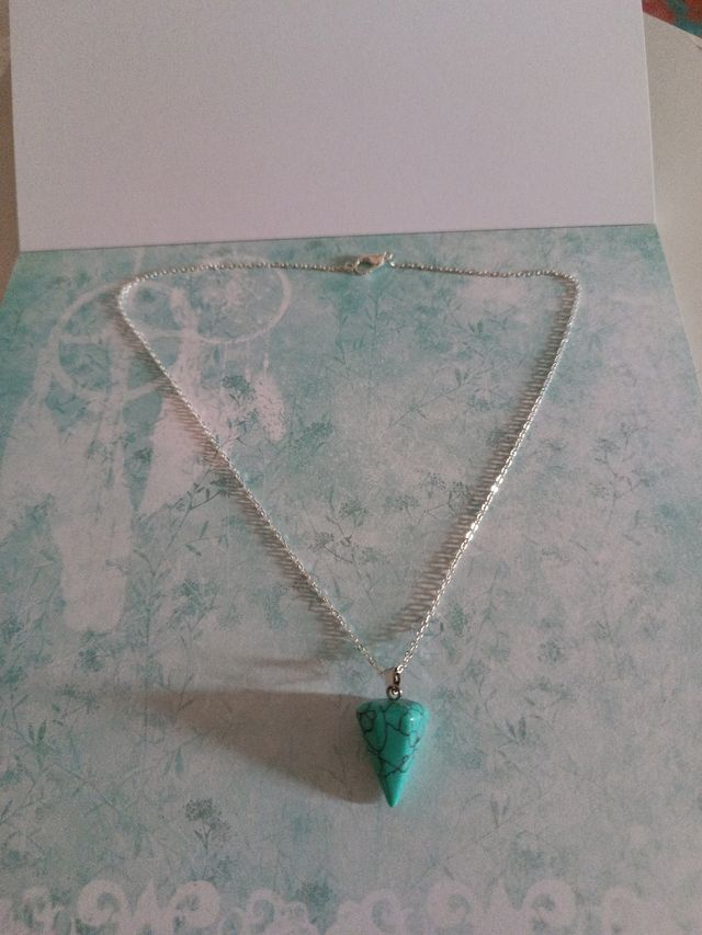 péndulo con cadena de plata