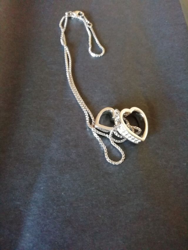 Colgante doble corazón. Acero.Nuevo