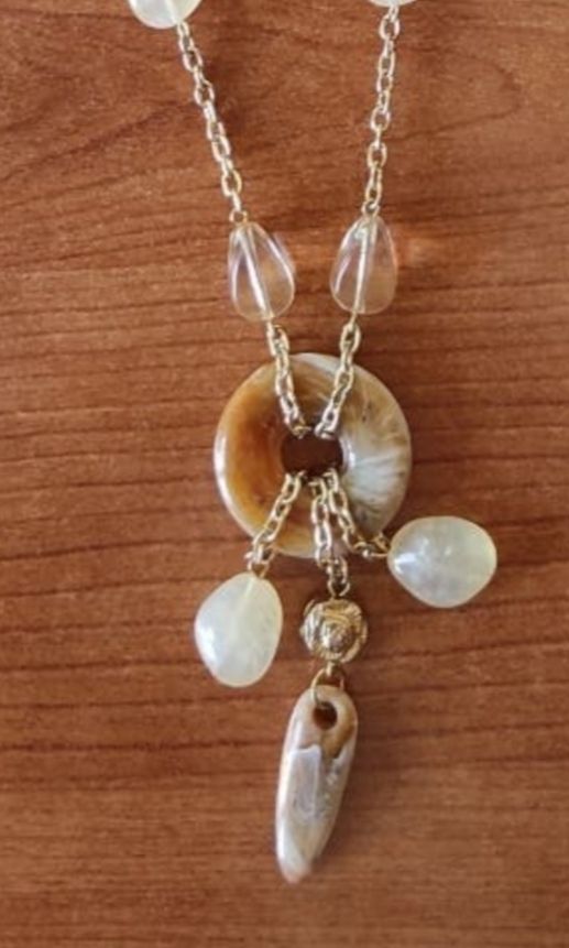 Collar con colgante con piedras y dorado.