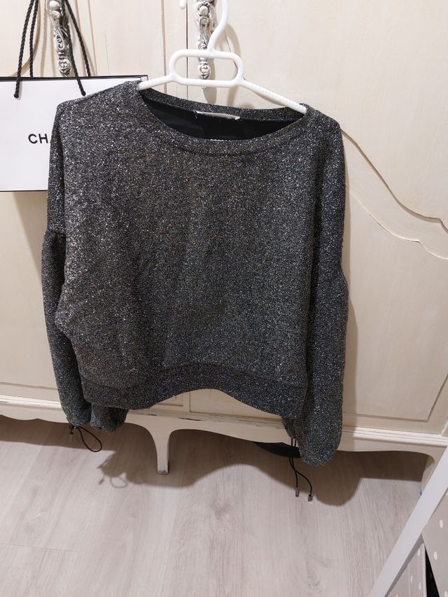 Suéter gris brillante con detalle en puños