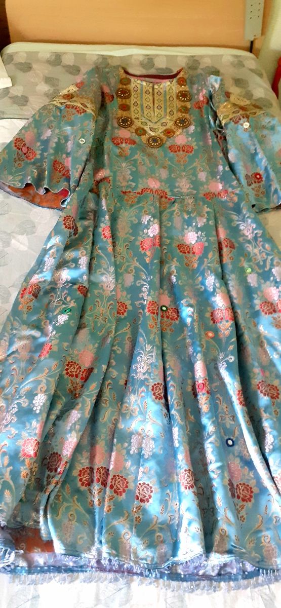 Túnica en brocado azul y pedrería.