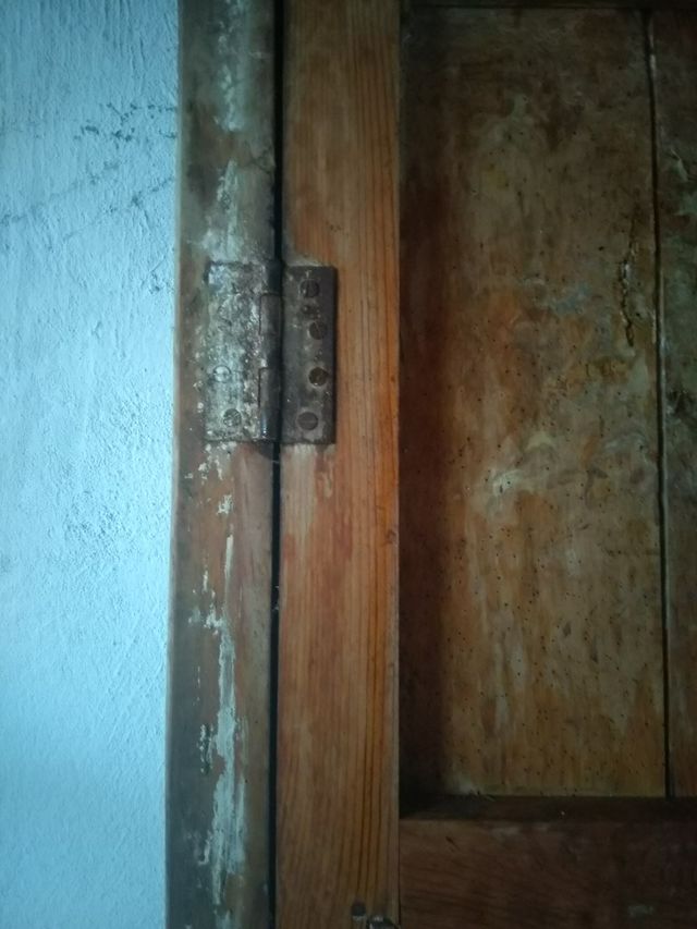 Antigua puerta de madera con cerrojo de hierro