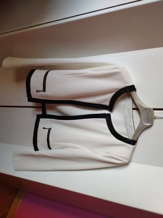 Torera blanca, ribete en polipiel negro.