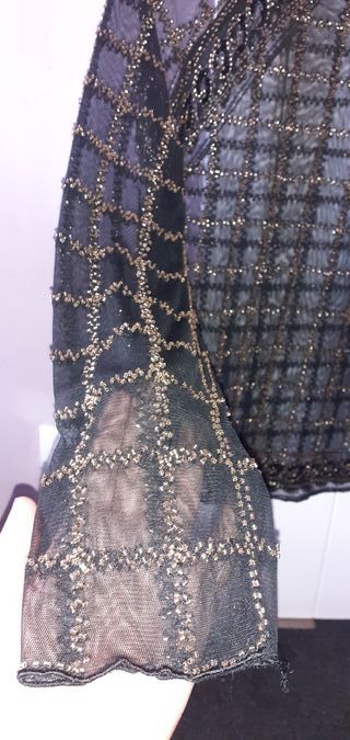 Blusa negra transparente con pedrería dorada