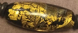 PULSERA EN ÓNIX CON PAPEL DE ORO.