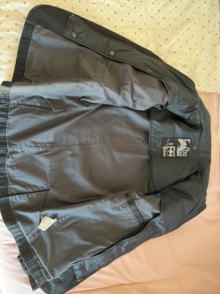 Chaqueta negra de pana lisa con forro interior.