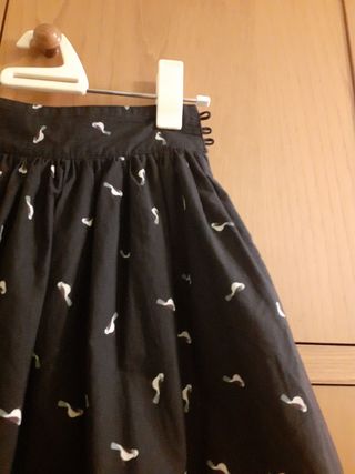 Falda negra, con dibujos y forro.