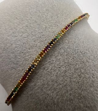 Pulsera riviere de 18 kt con zafiros, rubíes...