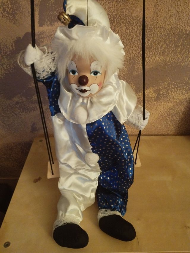 Payaso en columpio de porcelana