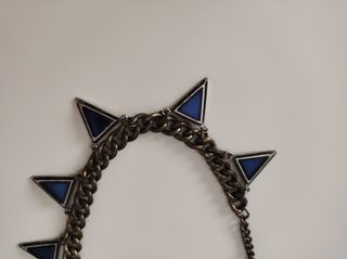 Collar dorado metálico con triángulos azules