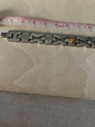 Pulsera acero inox con cabezas de león doradas