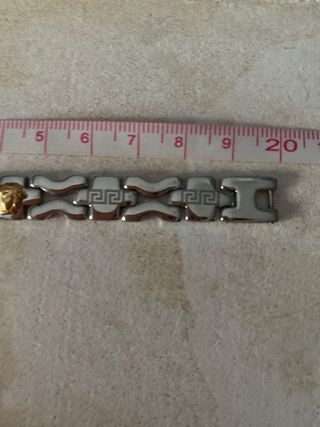 Pulsera acero inox con cabezas de león doradas