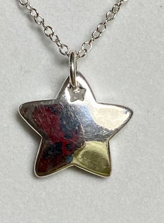Colgante “estrella” y cadena chapado plata ley 925