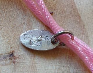 Pulsera de plata lotus con osito tous.