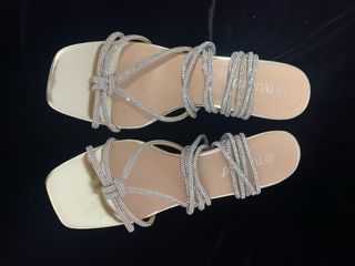 Sandalias oro con tiras de brillantes.