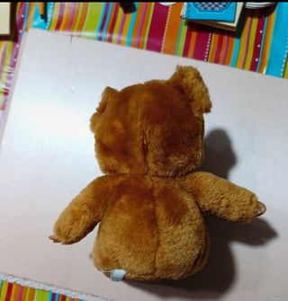 Bambolotto con biberon e giacca a forma di cane