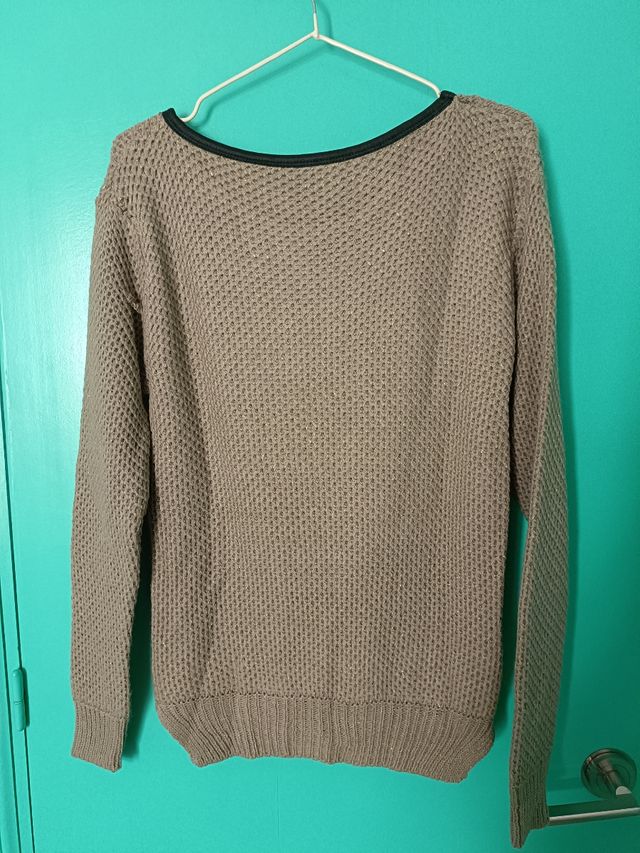 Jersey marrón con detalles dorados.