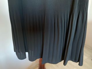 Elegante falda negra plisada, con pasamanería
