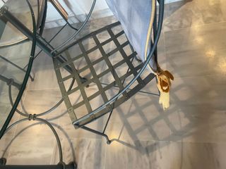 Mesa de cristal con 4 sillas y cojines.