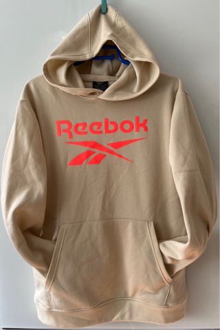 Sudadera con capucha Reebok beige/naranja flúor.
