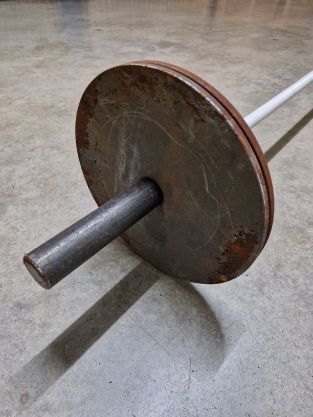 Barra halterofilia casera con discos.