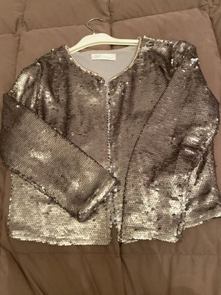 Chaqueta corta de lentejuelas color plateado.