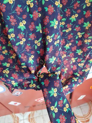 Blusa a motivo floreale semitrasparente.