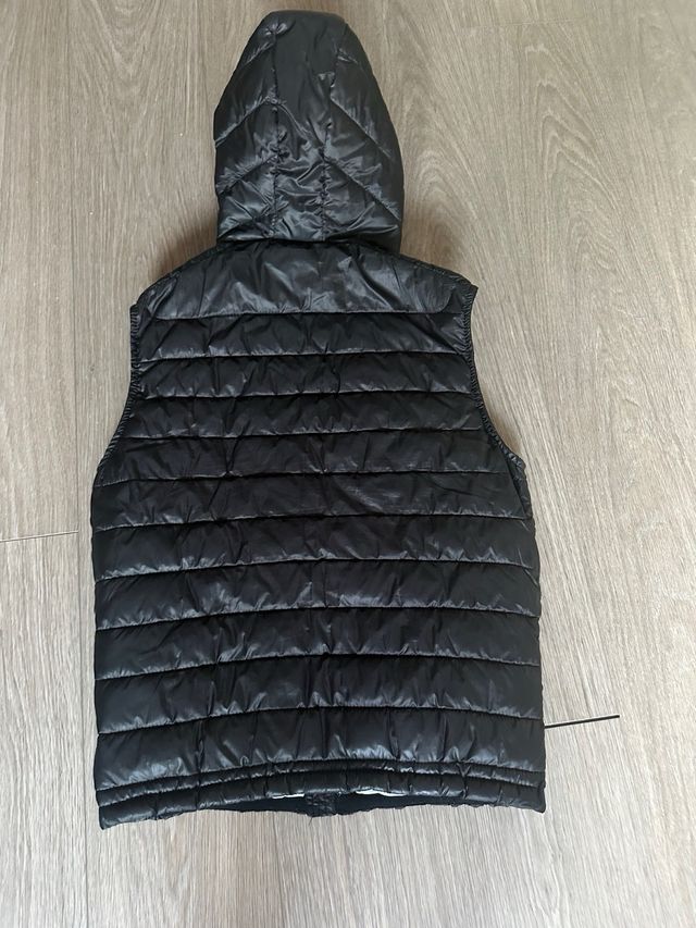 Chaleco tipo plumas de Bershka en negro. Talla S