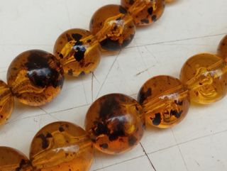 Antica collana in ambra con inserti in argento