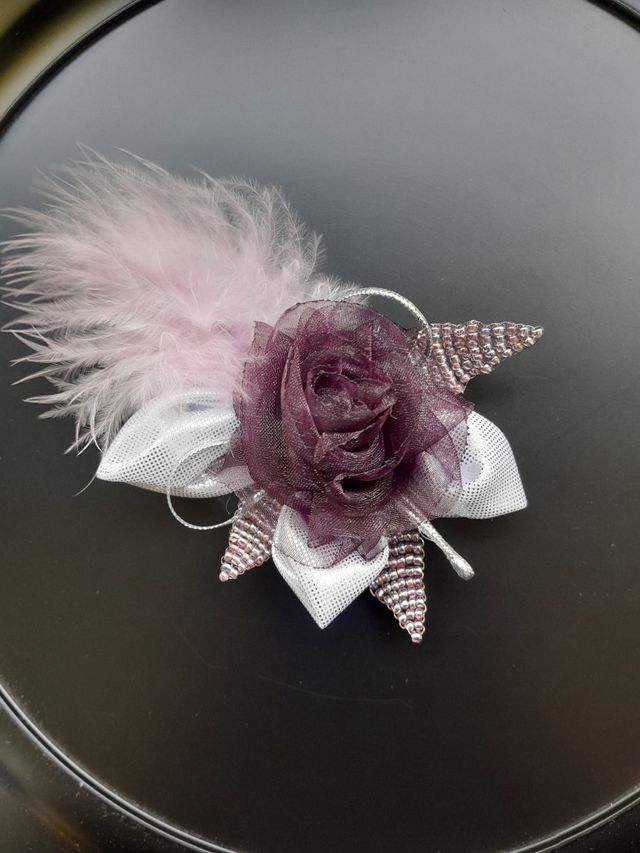 Broche de tela, cuentas y pluma