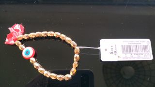 Pulsera elástica abalorios dorados y cuenta roja