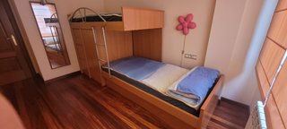Habitación juvenil con literas y escritorio.