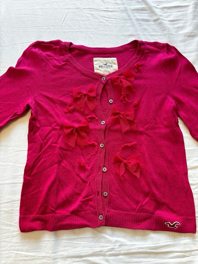 Chaqueta de punto fuxia con lacitos Hollister