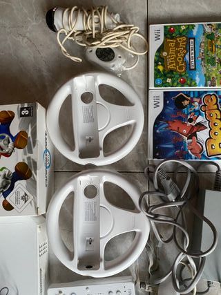 wii con 2 mandos, juegos y volantes para mariokart