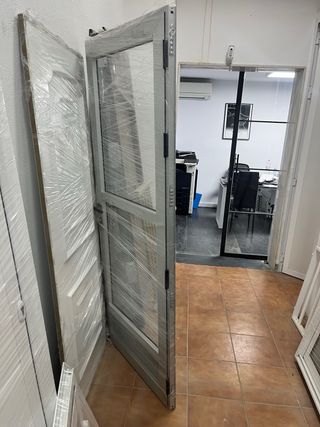 Puerta de entrada en color plata y cristal