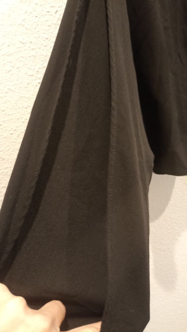 Camisa negra abertura mangas.