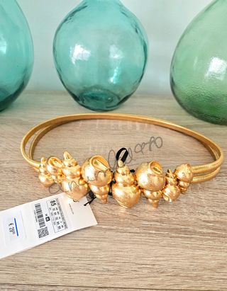 Cinturón metálico caracolas dorado zara