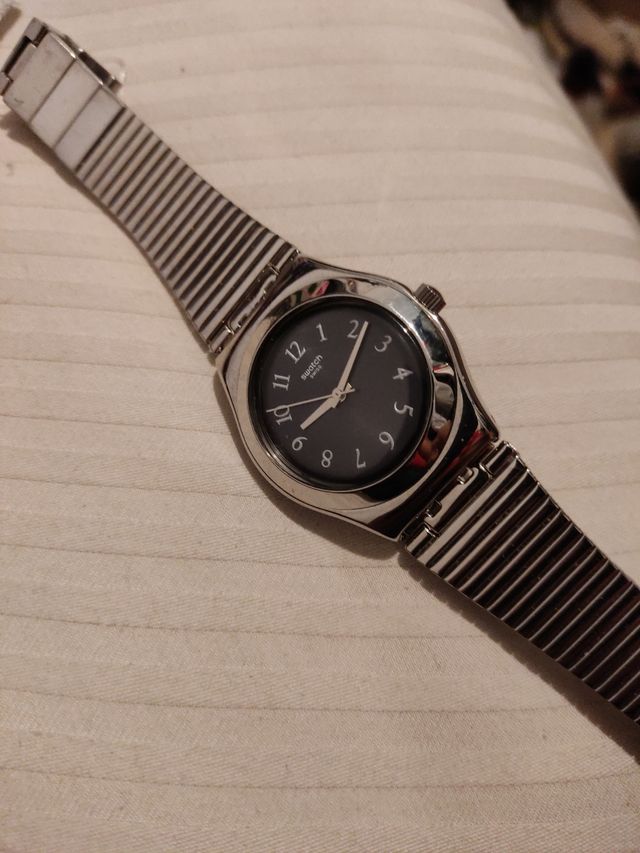 Reloj de acero marca Swatch.