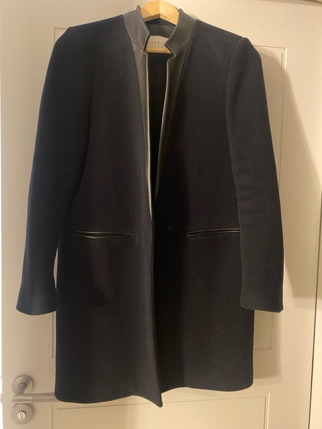 Cappotto in pelle nera con risvolto blu marino