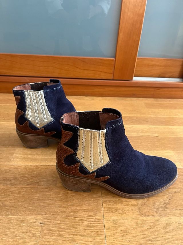 Botín campero ante azul marino