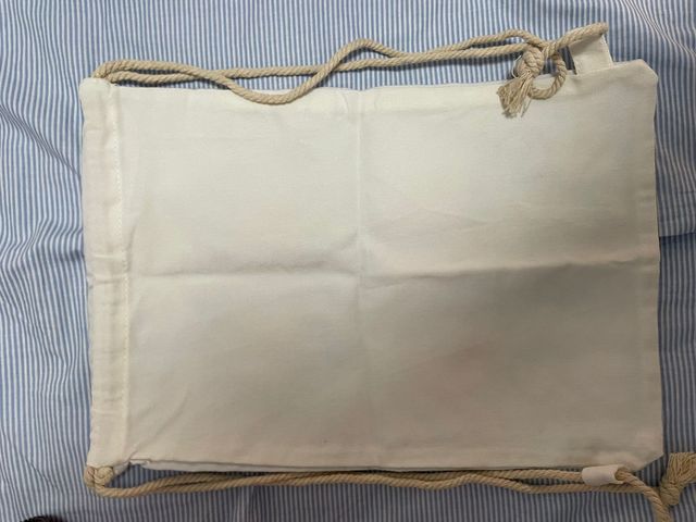 Mochila de tela más bolígrafo con pom