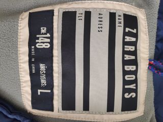 Chaleco plumas de niño, 10 años.