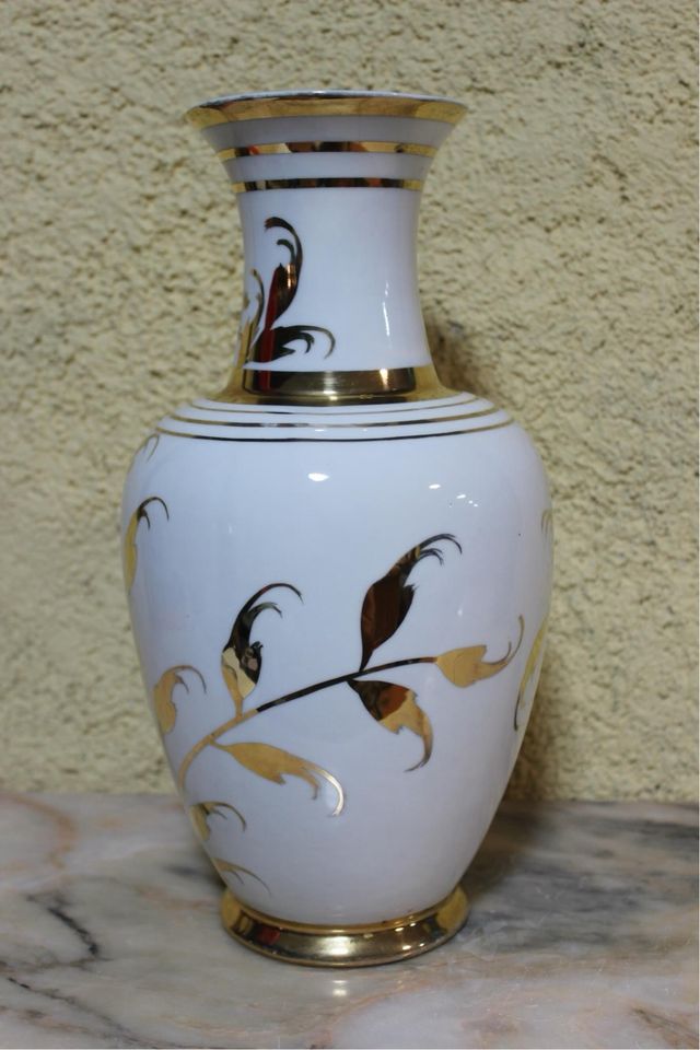 Jarrón de porcelana con flores doradas.