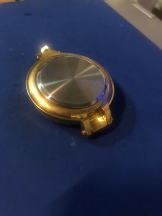 Reloj bosillo dorado y plata.
