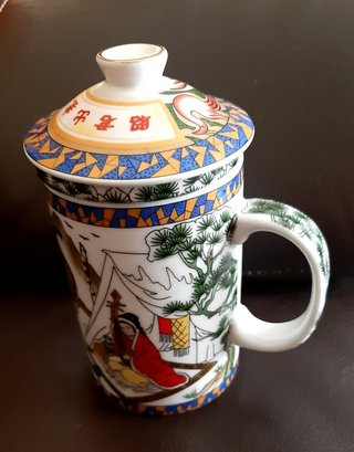 Taza de té con tapa y colador
