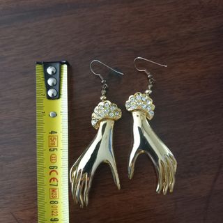 Orecchini pendenti mano di donna dorati