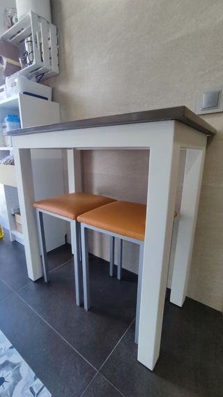 Mesa auxiliar cocina con taburetes.