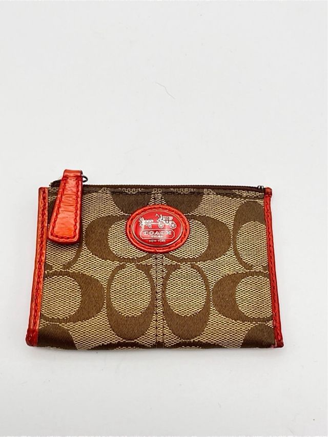 Portamonete Coach marrone in tessuto e in pelle
